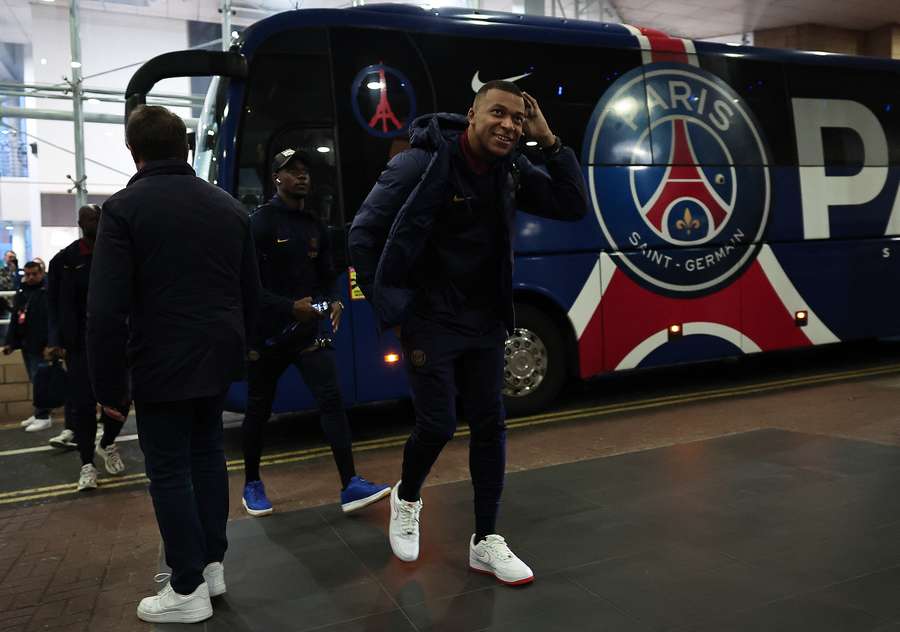 Kylian Mbappé walks off the PSG team bus ahead of their match against Newcastle