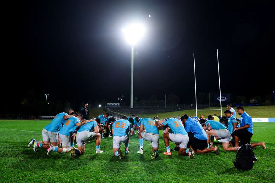 Moana Pasifika players huddle during a partial blackout at North Harbour Stadium.
