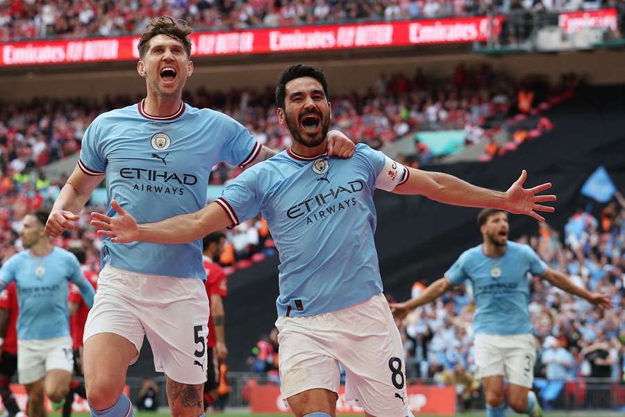 John Stones celebrates with goalscorer Manchester City's German midfielder Ilkay Gundogan 