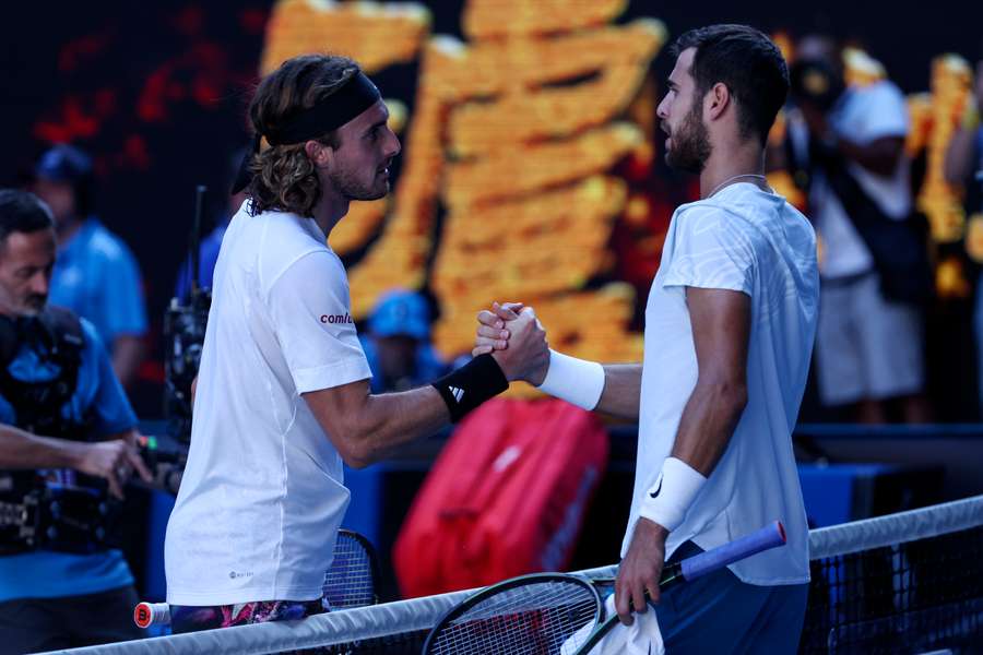 Greece's Stefanos Tsitsipas (L) shakes hands with Russia's Karen Khachanov