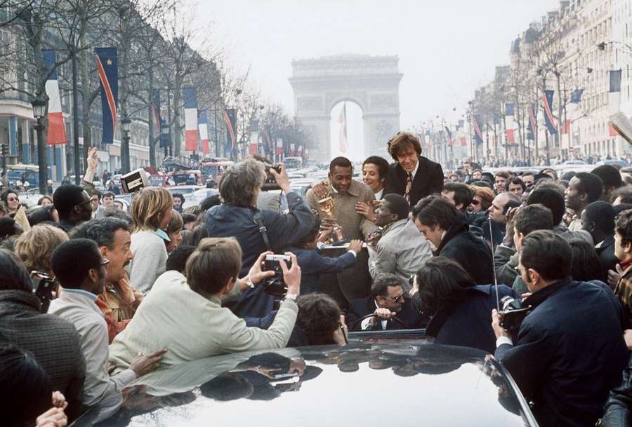 In this file photo taken on March 30, 1971 Brazilian soccer star Pele is surrounded by a huge crowd 30 March 1971 at the Champs-Elysées in Paris.