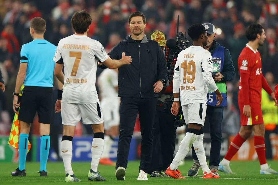 Bayer Leverkusen's Xabi Alonso meets his players after losing to Liverpool in midweek