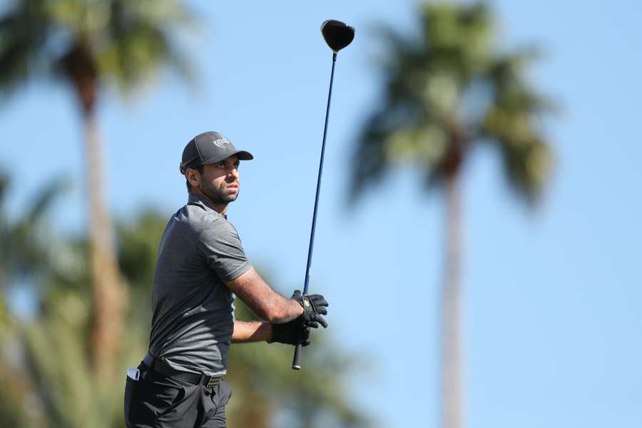 Aaron Rai of England plays his shot from the ninth tee