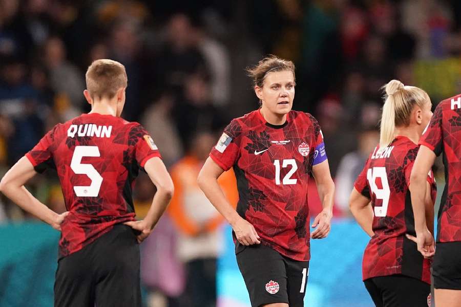 Sinclair (12) and teammates react after conceding