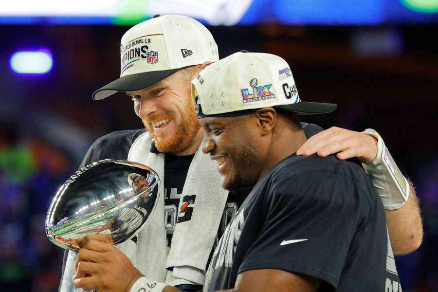 Seattle Seahawks' Sam Darnold and Kenneth Walker III celebrate with the Vince Lombardi Trophy 