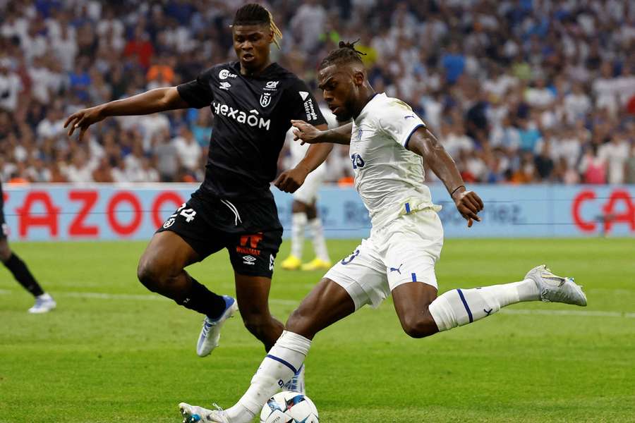 Reims' Emmanuel Agbadou, left, in action