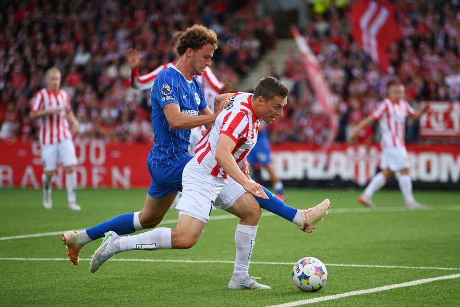 Ruben Yttergard Jenssen of Tromso IL is challenged by Mats Wieffer of Brighton 