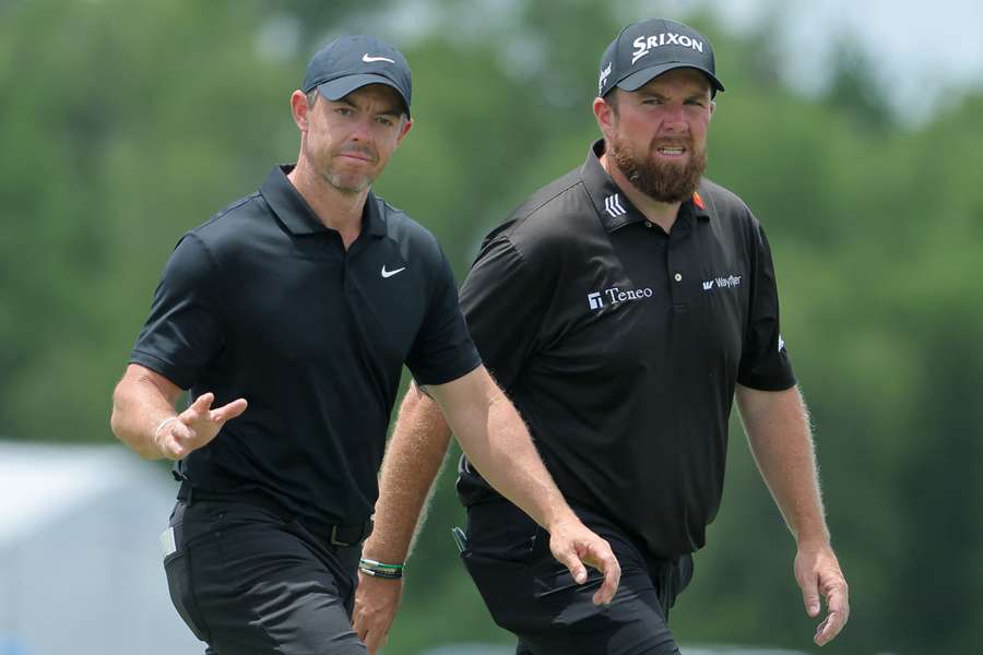 Rory McIlroy and Shane Lowry wave to fans during the second round of the Zurich Classic of New Orleans at TPC Louisiana