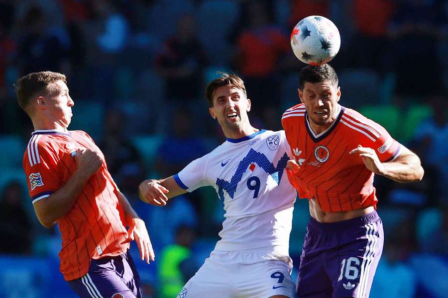 Scotland's Scott McKenna heads the ball away from Slovenia's Andraz Sporar