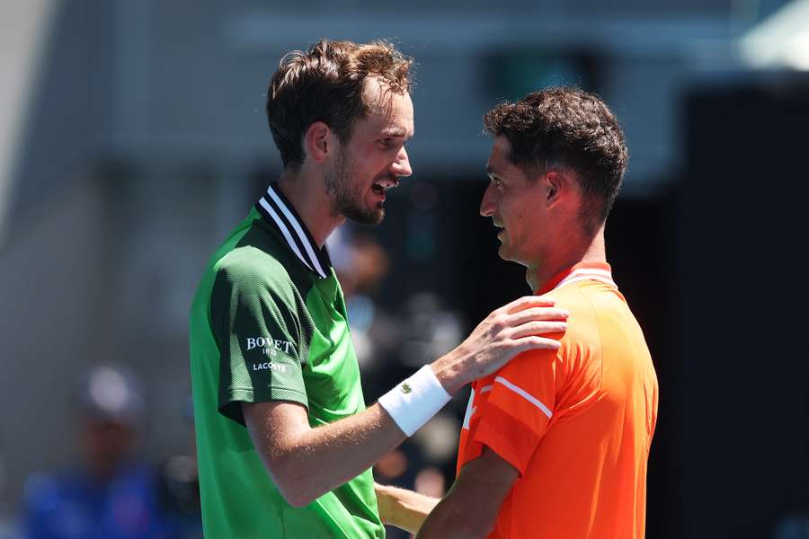 Terence Atmane (R) shakes hands with Daniil Medvedev after retiring injured