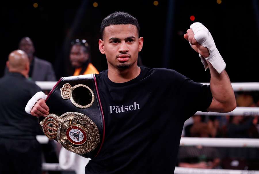 Romero poses with the WBA belt after his win