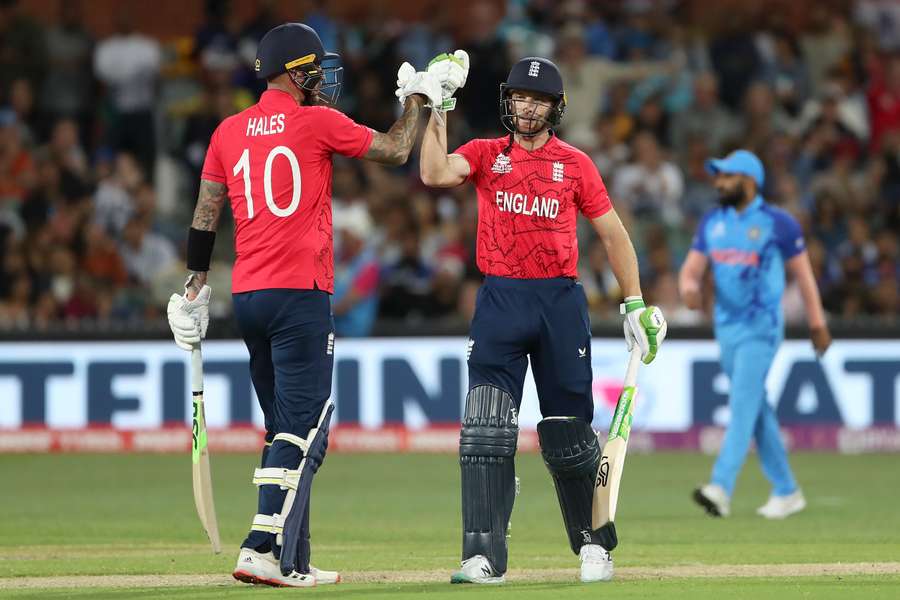 England's Captain Jos Buttler (R) and Alex Hales bump gloves 