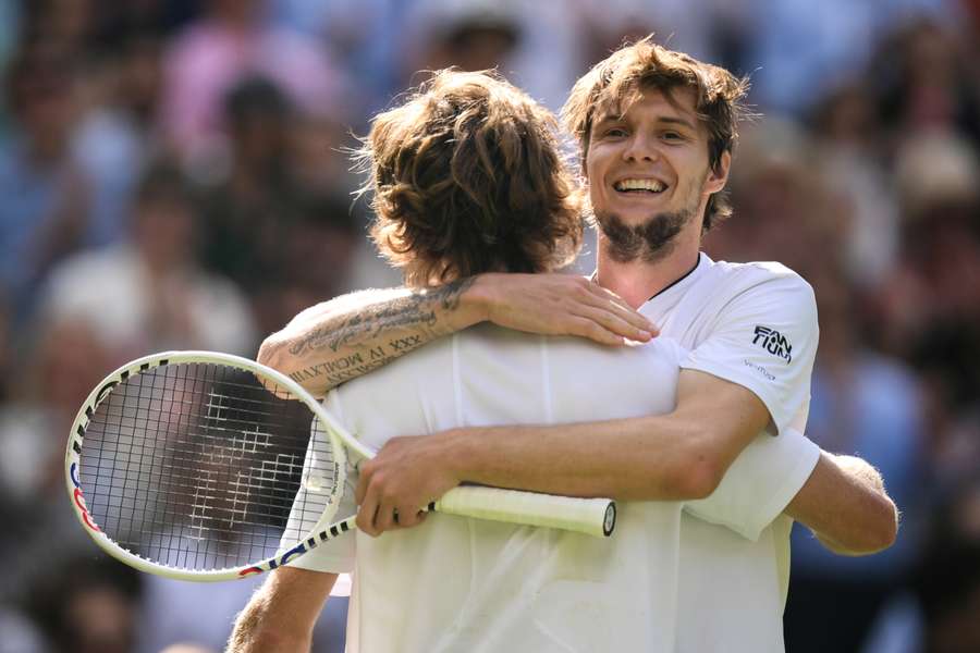 Russia's Andrey Rublev (L) hugs Kazakhstan's Alexander Bublik after winning their men's singles tennis match