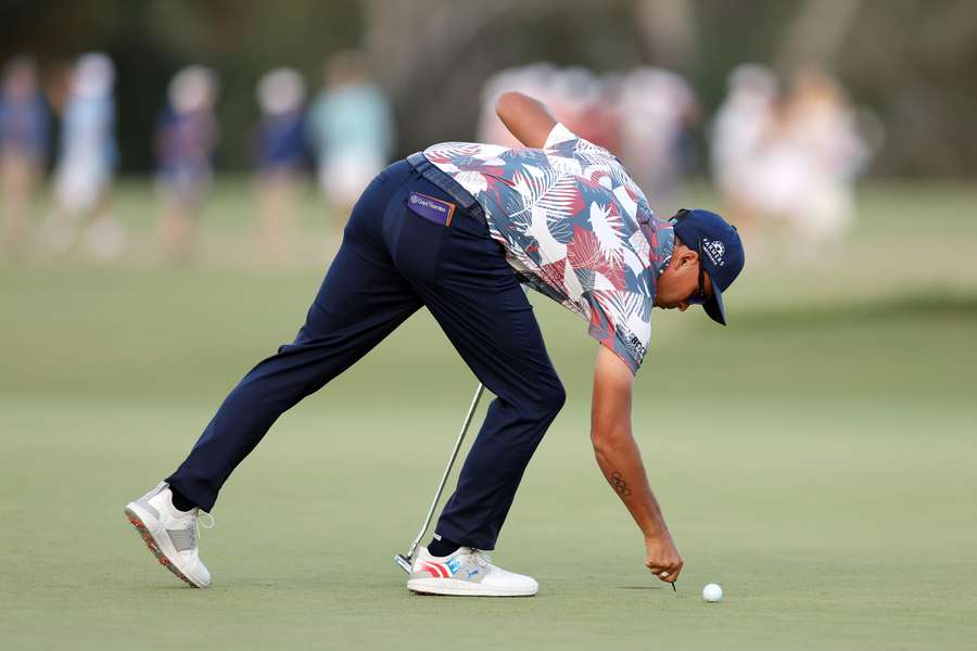 Rickie Fowler of the United States prepares to putt on the 18th green during the second round