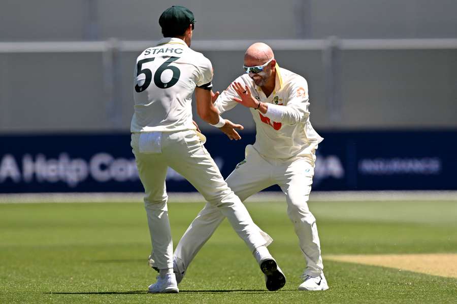 Nathan Lyon celebrates the wicket that saw him become Australia's all-time second highest Test wicket-taker.