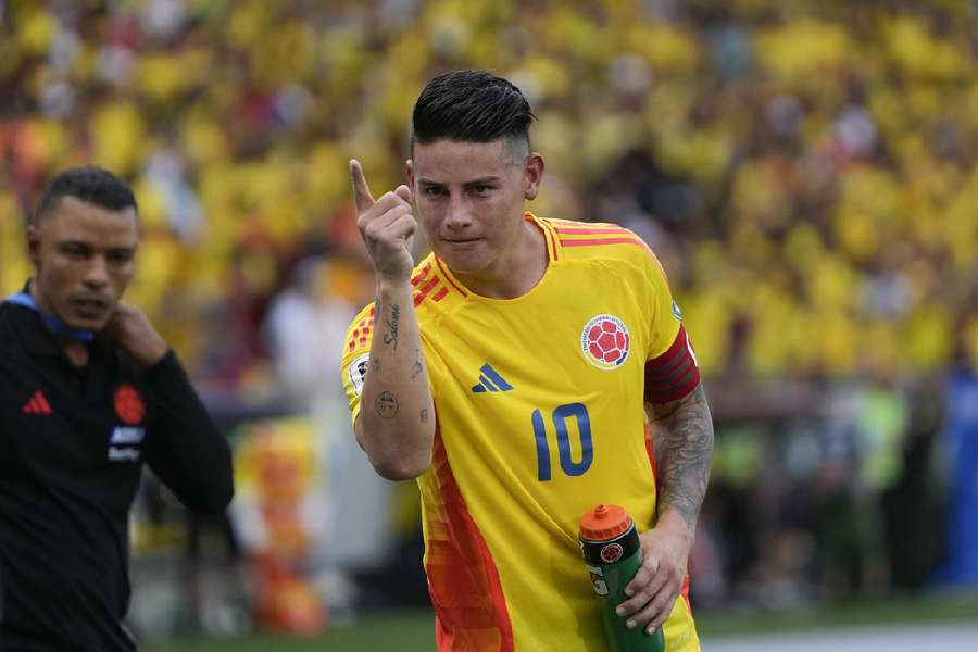 Colombia's James Rodriguez celebrates scoring a penalty, his side's second goal, against Argentina