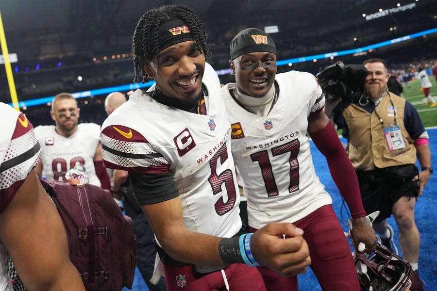 Washington Commanders quarter Jayden Daniels (5) and wide receiver Terry McLaurin (17) celebrating after upsetting the Detroit Lions