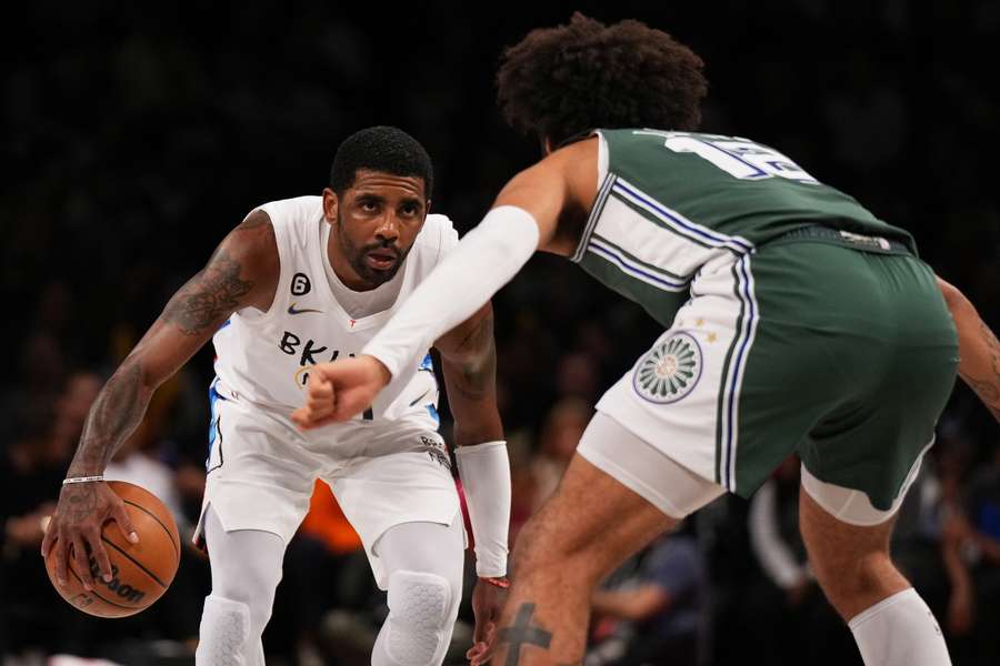 Kyrie Irving #11 of the Brooklyn Nets drives to the basket against Isaiah Livers #12 of the Detroit Pistons