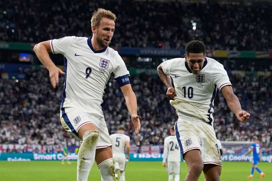 England's Harry Kane, left, celebrates with Jude Bellingham after scoring his side's second goal 