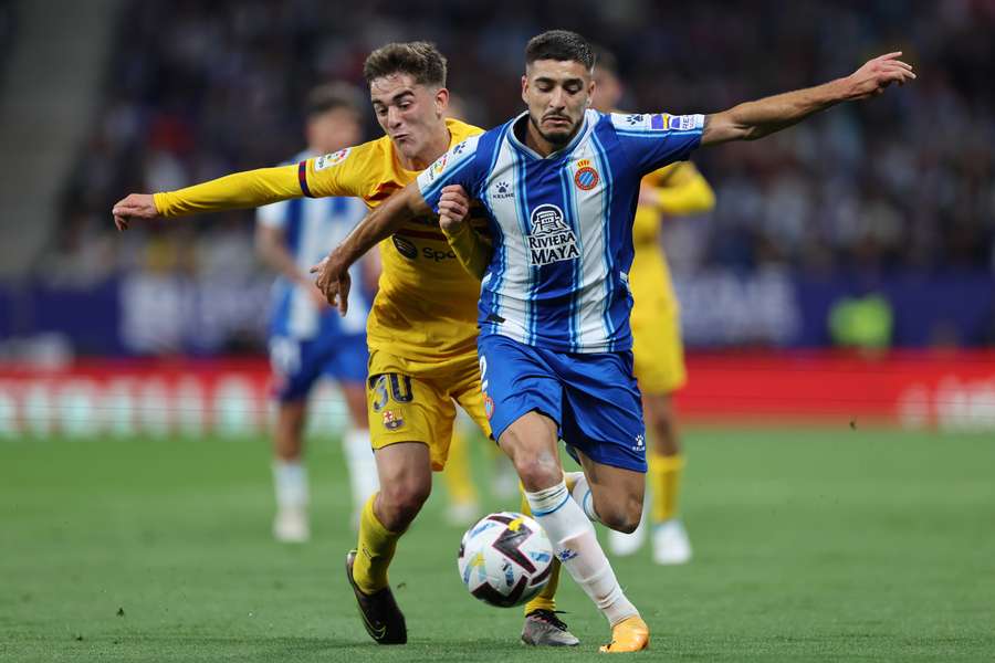 Barcelona midfielder Gavi (L) vies with Espanyol defender Oscar Gil