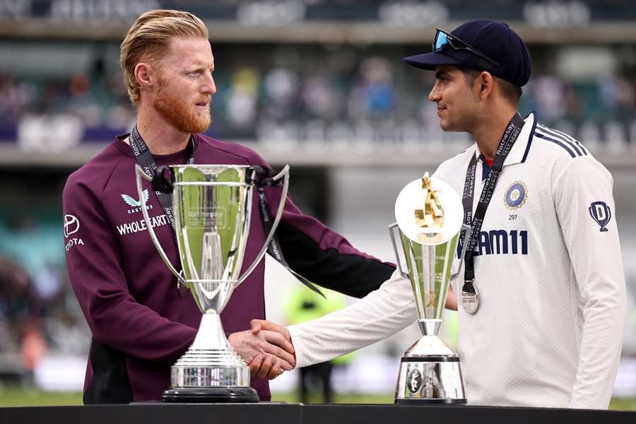 England's Ben Stokes (L) and India's Shubman Gill (R) shake hands at the presentation