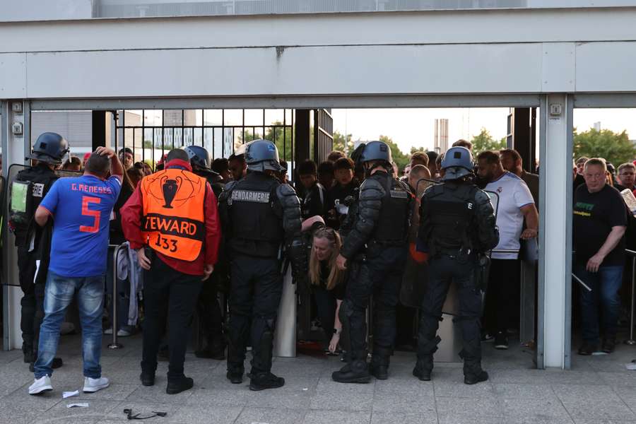 Police patrol the gates as some fans were prevented from getting inside