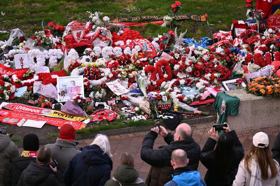 Flowers and photographs can be seen at a memorial for Diogo Jota set up close to Anfield