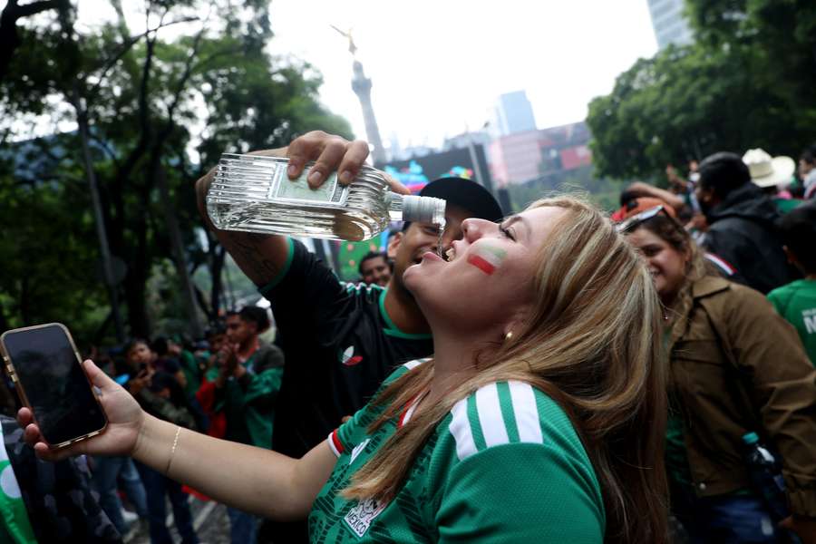 Mexico fans drink as they gather in Mexico City before the match. Mexico fans drink as they gather in Mexico City before the match.
