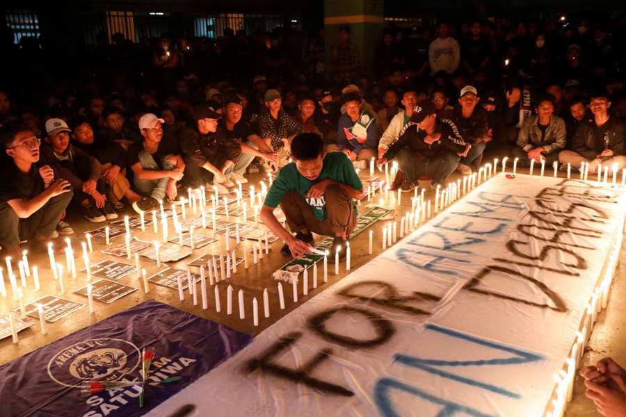 Supporters gather during a vigil in honour of those lost in the stampede.