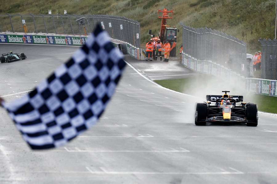 Max Verstappen crosses the line to win his ninth-straight race in F1