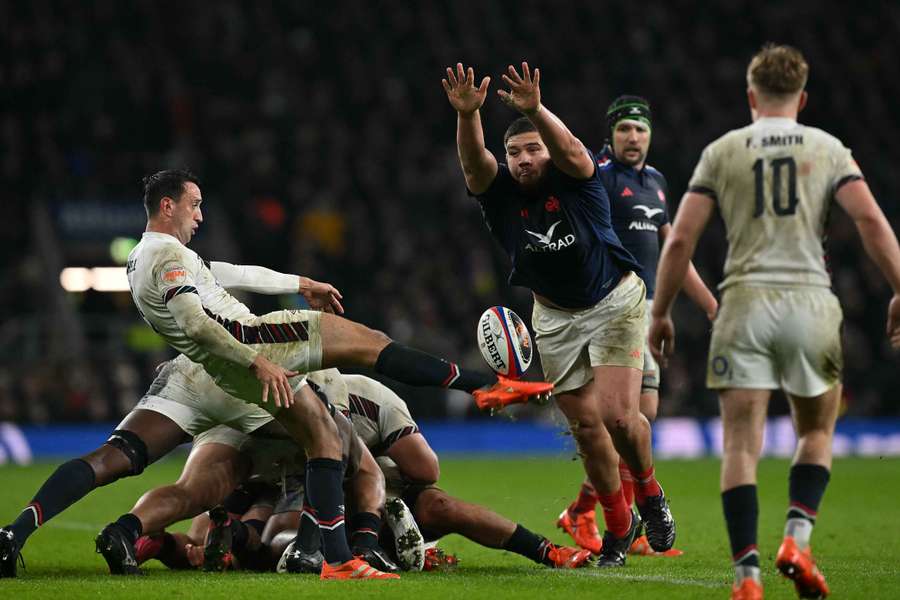 France's lock Emmanuel Meafou charges down a kick from England's scrum-half Alex Mitchell 