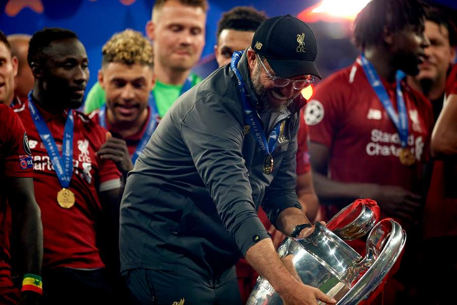 Jurgen Klopp, centre, holding the Champions League trophy after Liverpool's win over Tottenham Hotspur in 2019