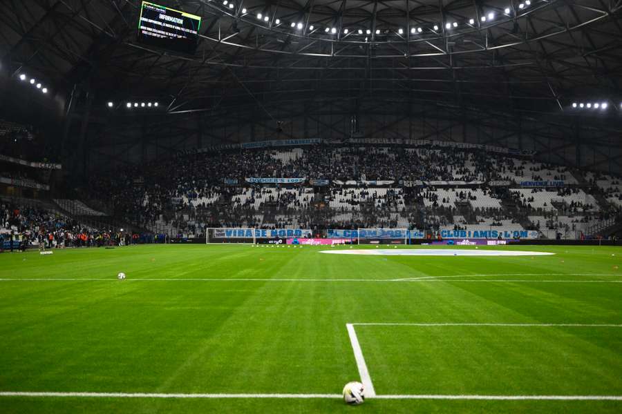 Spectators leave the Stade Velodrome after the French Ligue 1 match between Marseille and Lyon was postponed