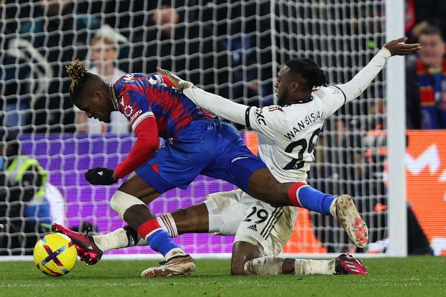 Zaha and Wan-Bissaka battle for the ball