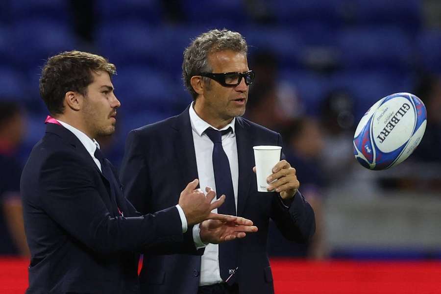 France's Antoine Dupont and head coach Fabien Galthie on the pitch before the match