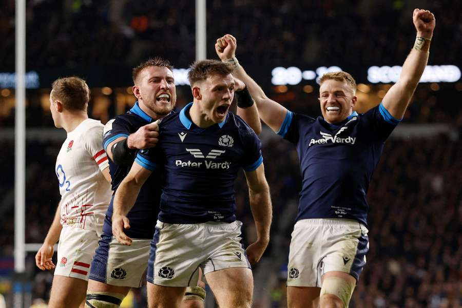 Ben White celebrates scoring their third try with teammates