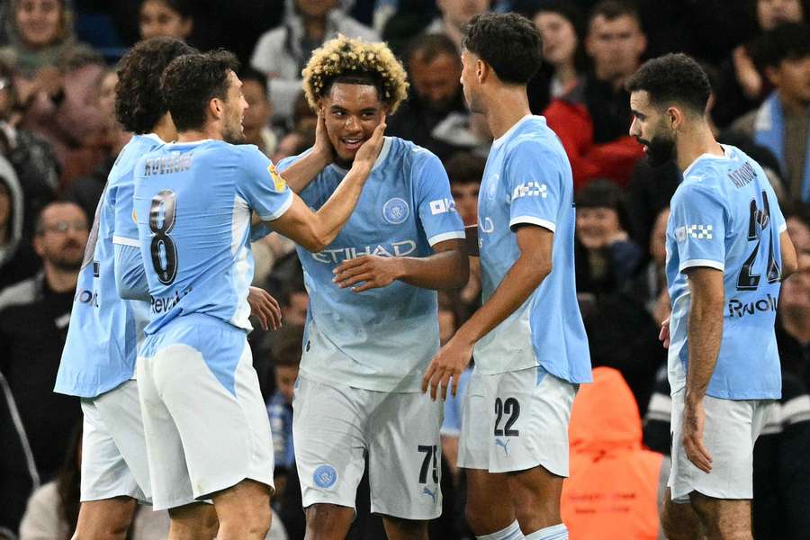 Floyd Samba (c) celebrates scoring the opening goal for Man City against Norwich