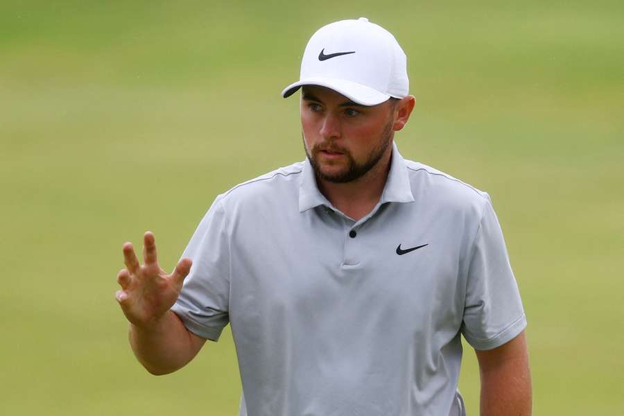 England's Alex Fitzpatrick celebrates making a birdie on the 18th green during the third round