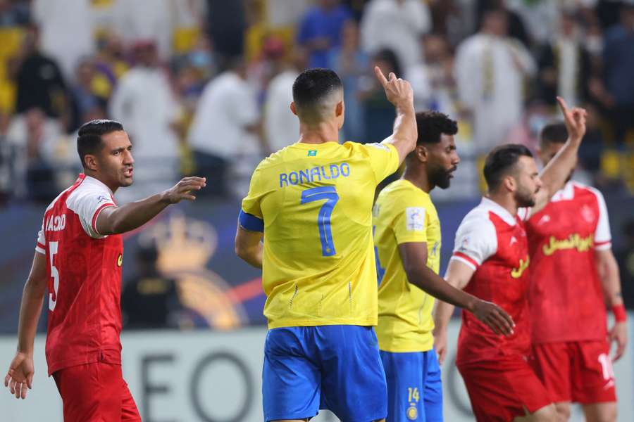 Cristiano Ronaldo wags his finger and says there was no foul after the referee awarded a penalty in the AFC Champions League