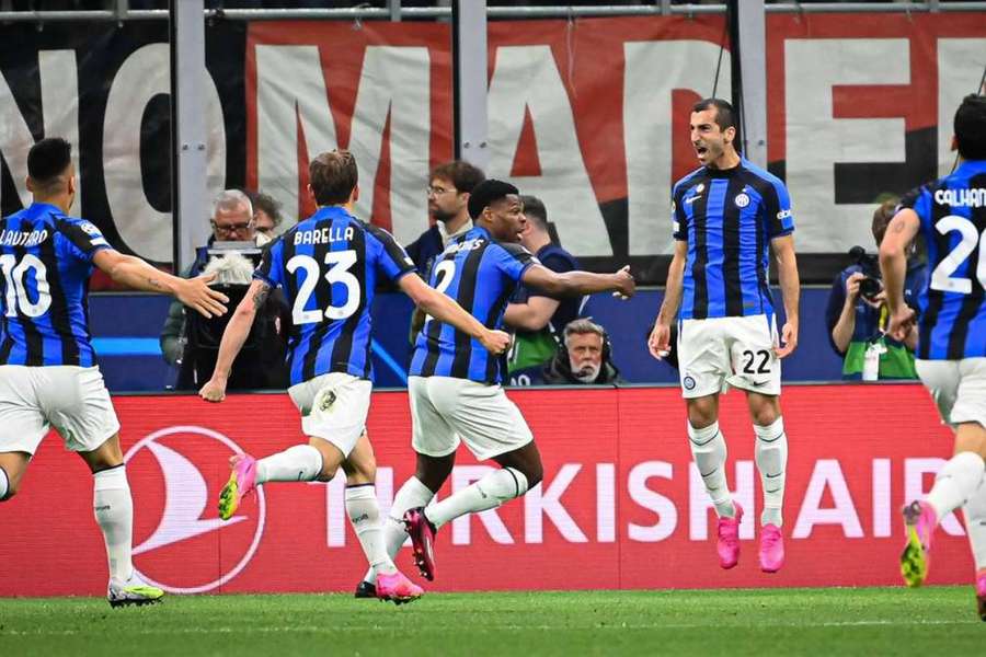 Henrikh Mkhitaryan jumps with joy after giving Inter a 2-0 lead over rivals AC Milan