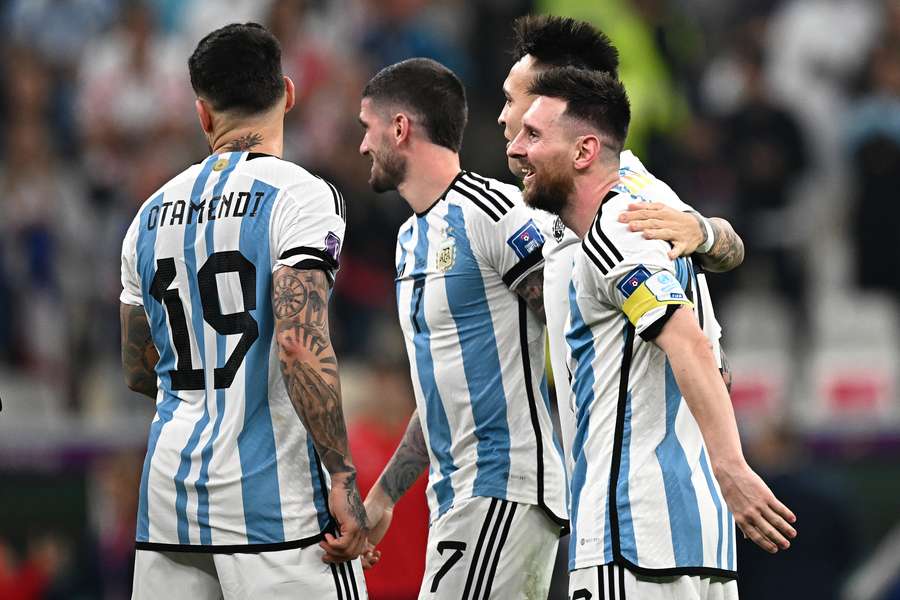 Lionel Messi celebrates with teammates after they won their World Cup football semi-final against Croatia