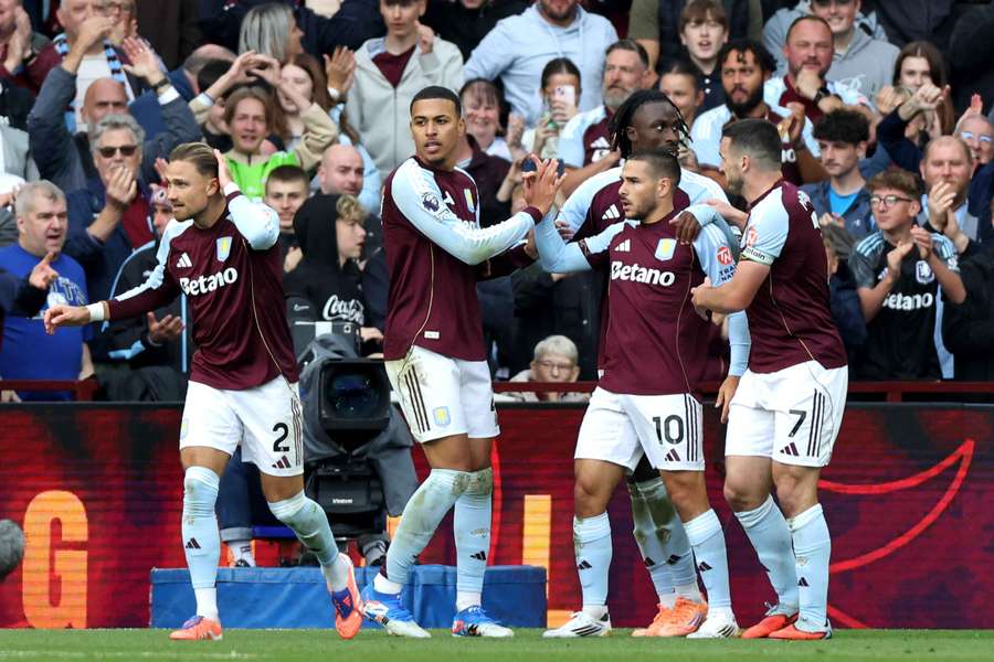Aston Villa's midfielder Emiliano Buendia (3R) celebrates scoring his team's third goal