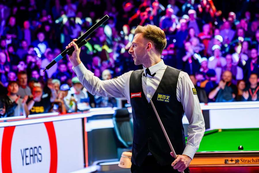 Judd Trump celebrates after winning the match against Barry Hawkins