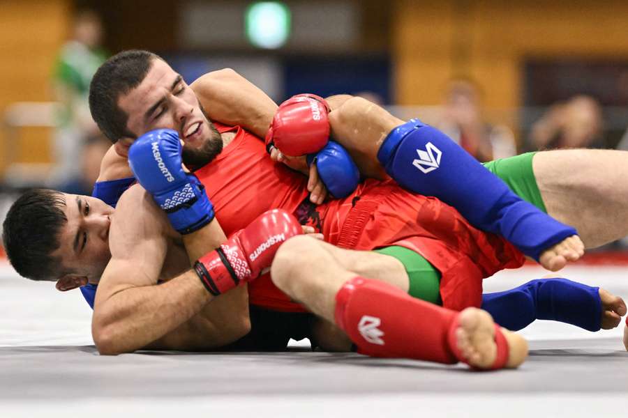 Tajikistan's Behruz Khurshedzoda (red) and Kyrgyzstan's Yryskeldi Duisheev compete in the men's modern -71kg semi-final MMA bout at the Asian Games Tajikistan's Behruz Khurshedzoda (red) and Kyrgyzstan's Yryskeldi Duisheev compete in the men's modern -71kg semi-final MMA bout at the Asian Games