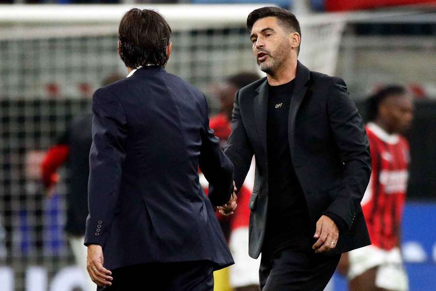 Inter Milan coach Simone Inzaghi shakes hands with AC Milan coach Paulo Fonseca after the match