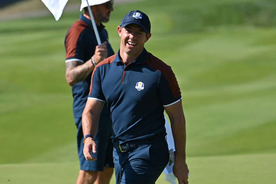 Europe's Northern Irish golfer Rory McIlroy smiles on the first green during practice ahead of the 44th Ryder Cup