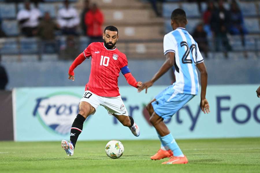 Egypt’s striker Mohamed Salah controls the ball as he is challenged by Botswana’s Thatayone Ditlhokwe