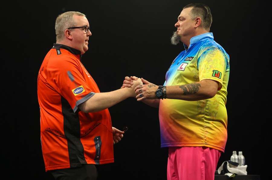 Stephen Bunting is congratulated by Stowe Buntz after the first quarter-final of the evening