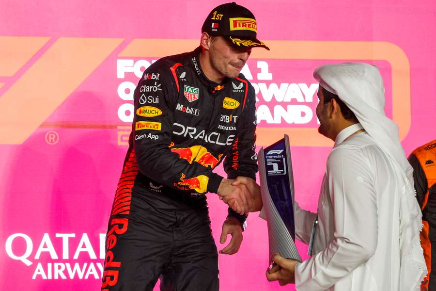 Red Bull Racing's Dutch driver Max Verstappen receives his first-place trophy on the podium 