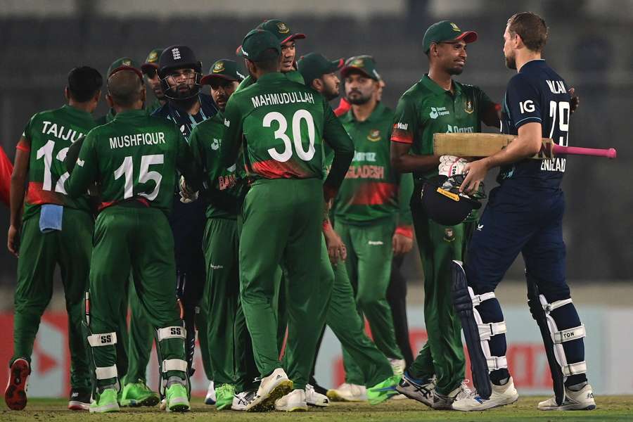 England's Adil Rashid and Dawid Malan are congratulated by Bangladesh's players at the end of the first one-day international